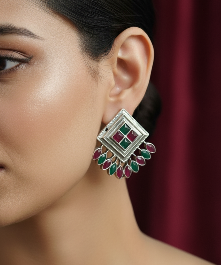 Close up of a women wearing square shape peacock inspired kundan earrings