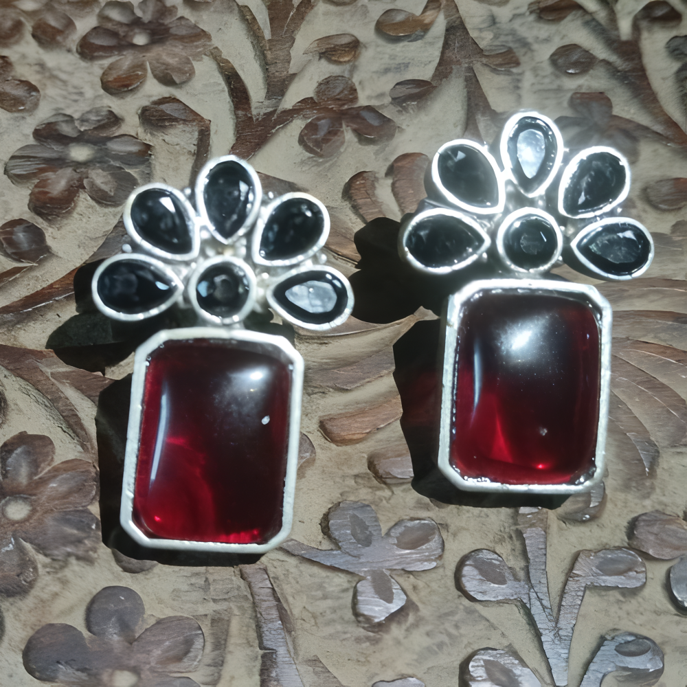 Stuearrings with red stones and silver floral designs