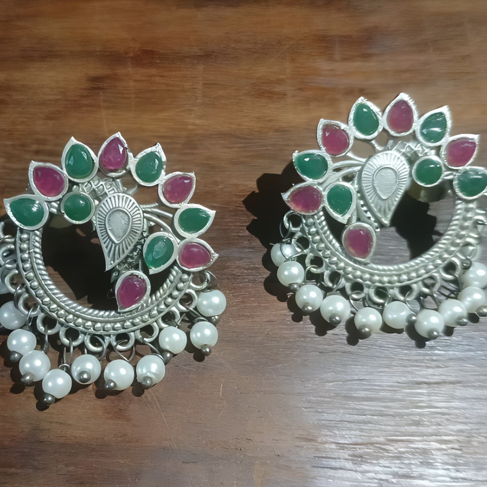 Pair of elegant ornate multicolor stud earrings for women .