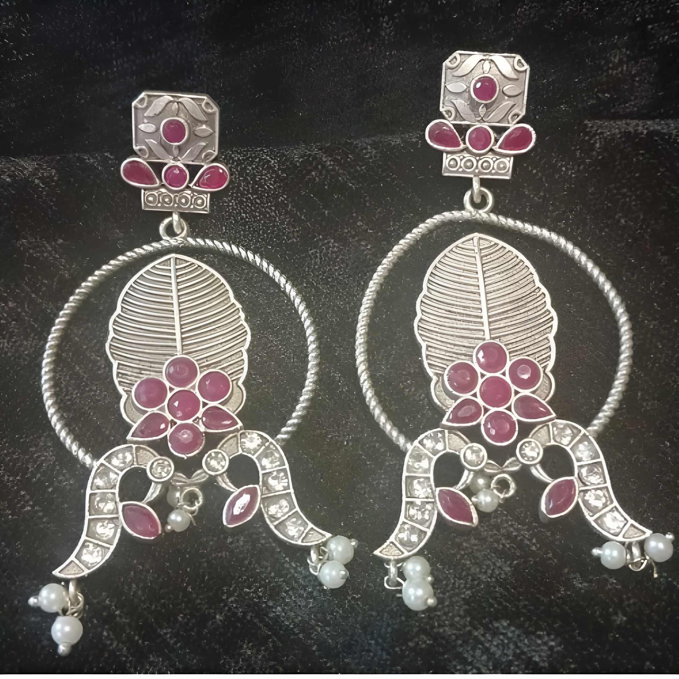 Pair of silver earrings with pink gemstones and pearl-like beads