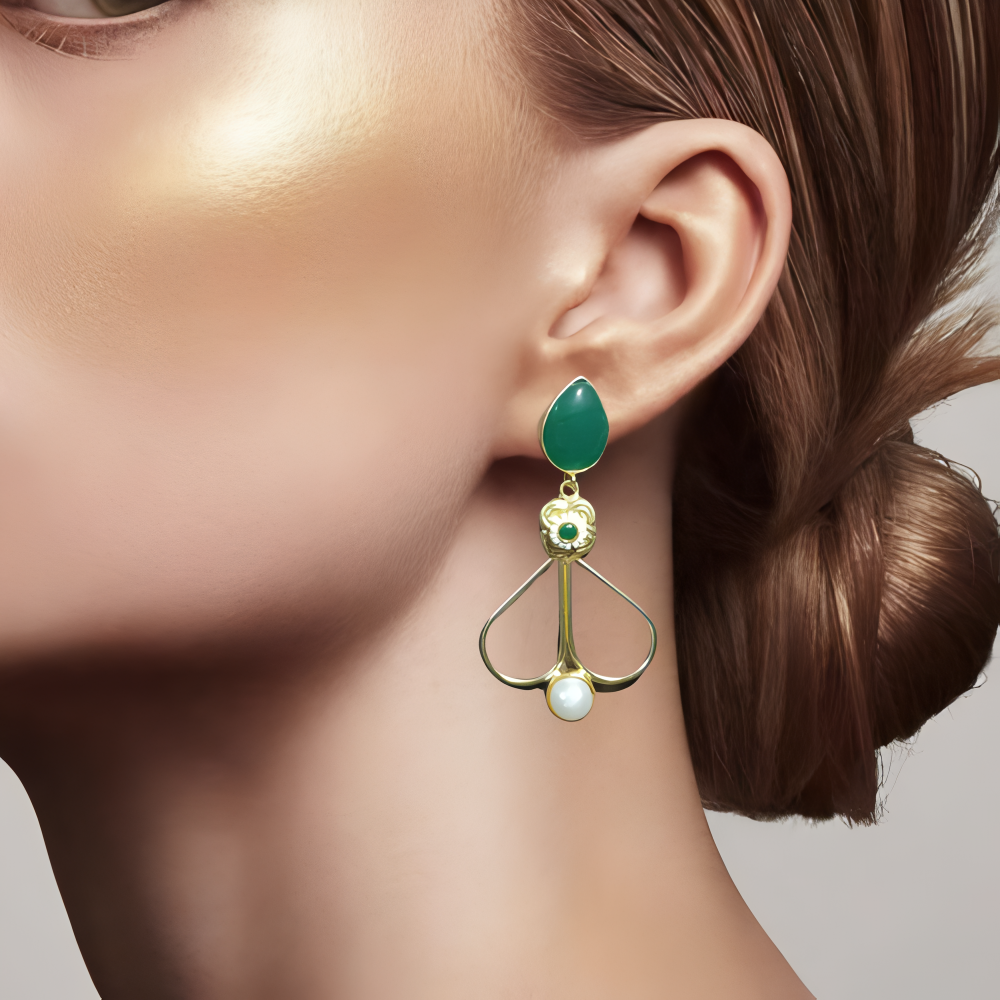 A model wearing gold earrings with green stone & white pearl