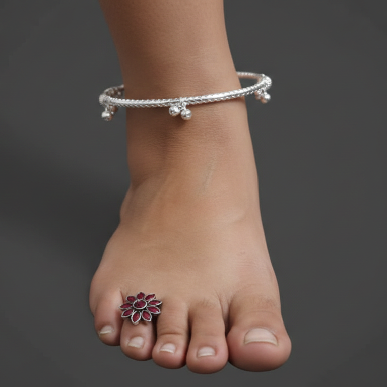 Ankle bracelet on a foot with a dark background