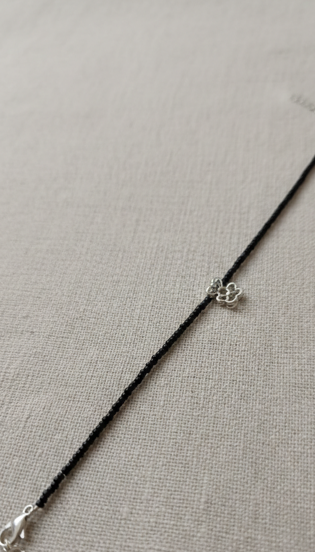 Minimalist anklet with adjustable chain on a woman's ankle