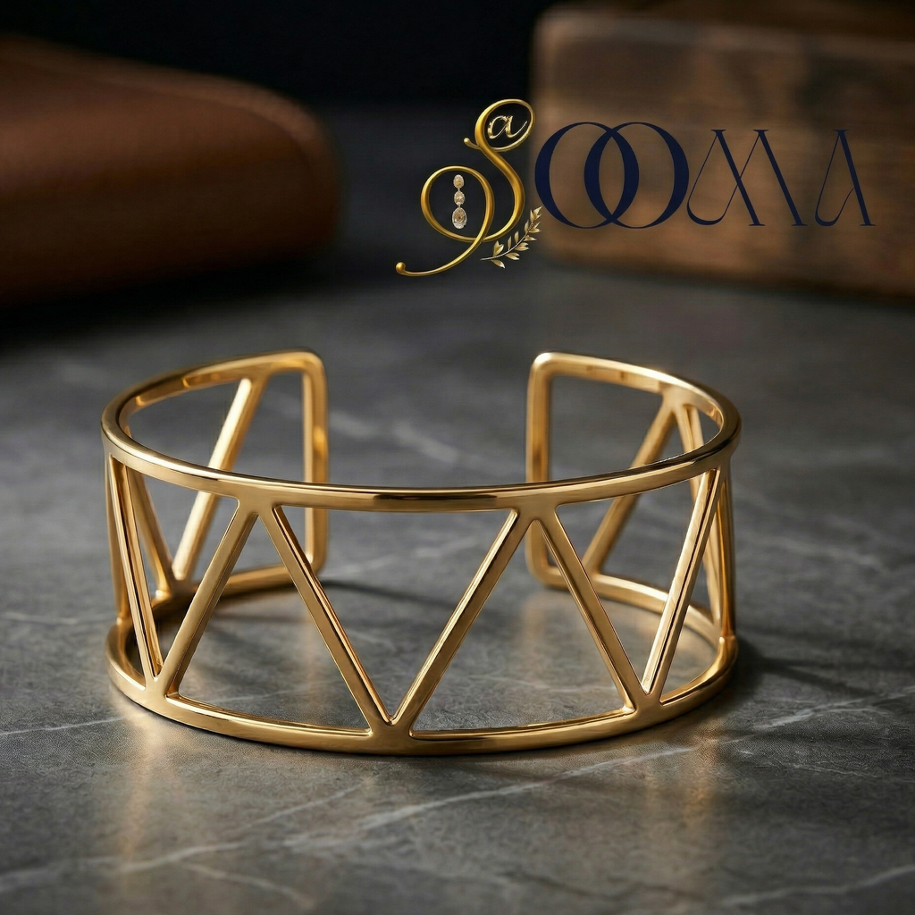 Gold geometric bracelet on a dark surface with a brand logo above.