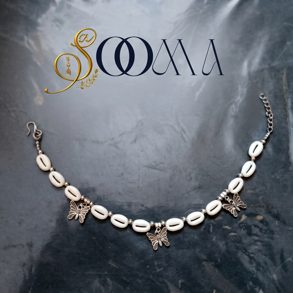 Minimalist shell ankle jewelry with antique silver charms close up