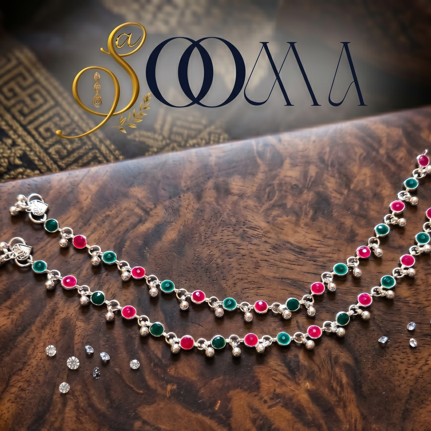Oxidized silver ankle jewelry with green and red faux stones close up