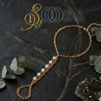 Minimalist attached toe ring payal with a strand of round white pearls close up