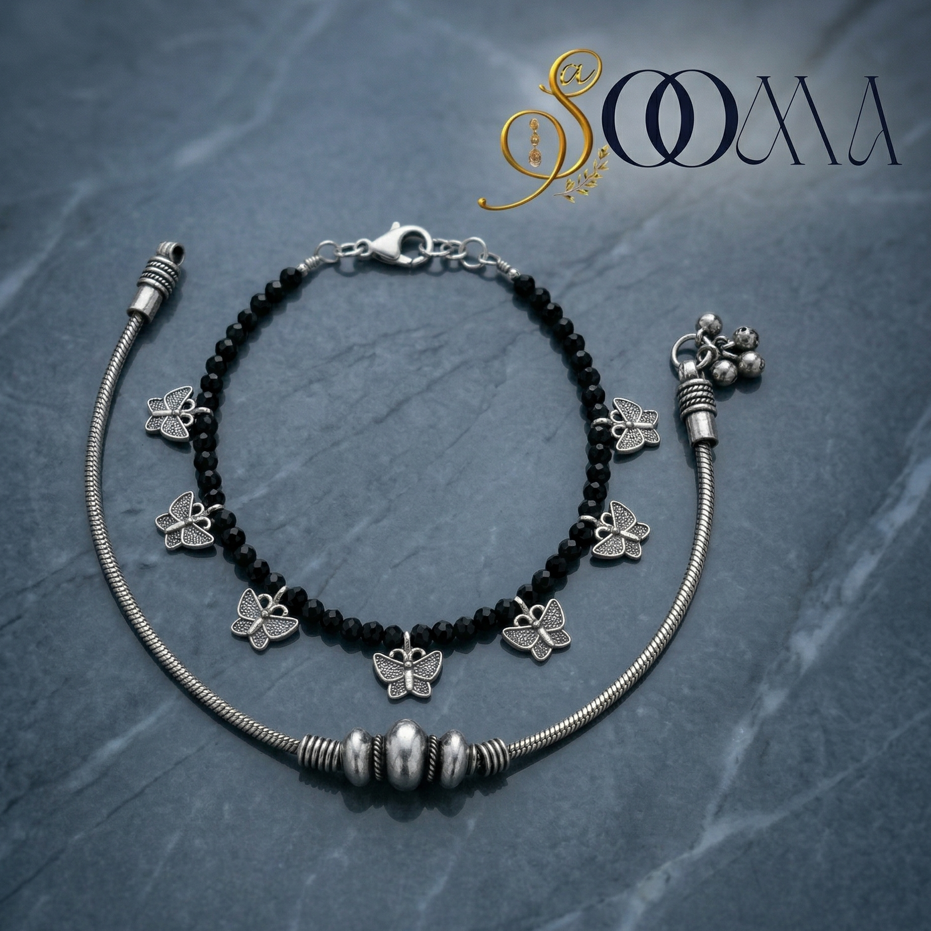 Silver anklet with black beads and butterfly charms with a metal anklet, featuring the brand 'Sooma'.