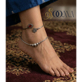 Close-up of an Ankle with stone anklet kada showing the metal finish and stone settings.