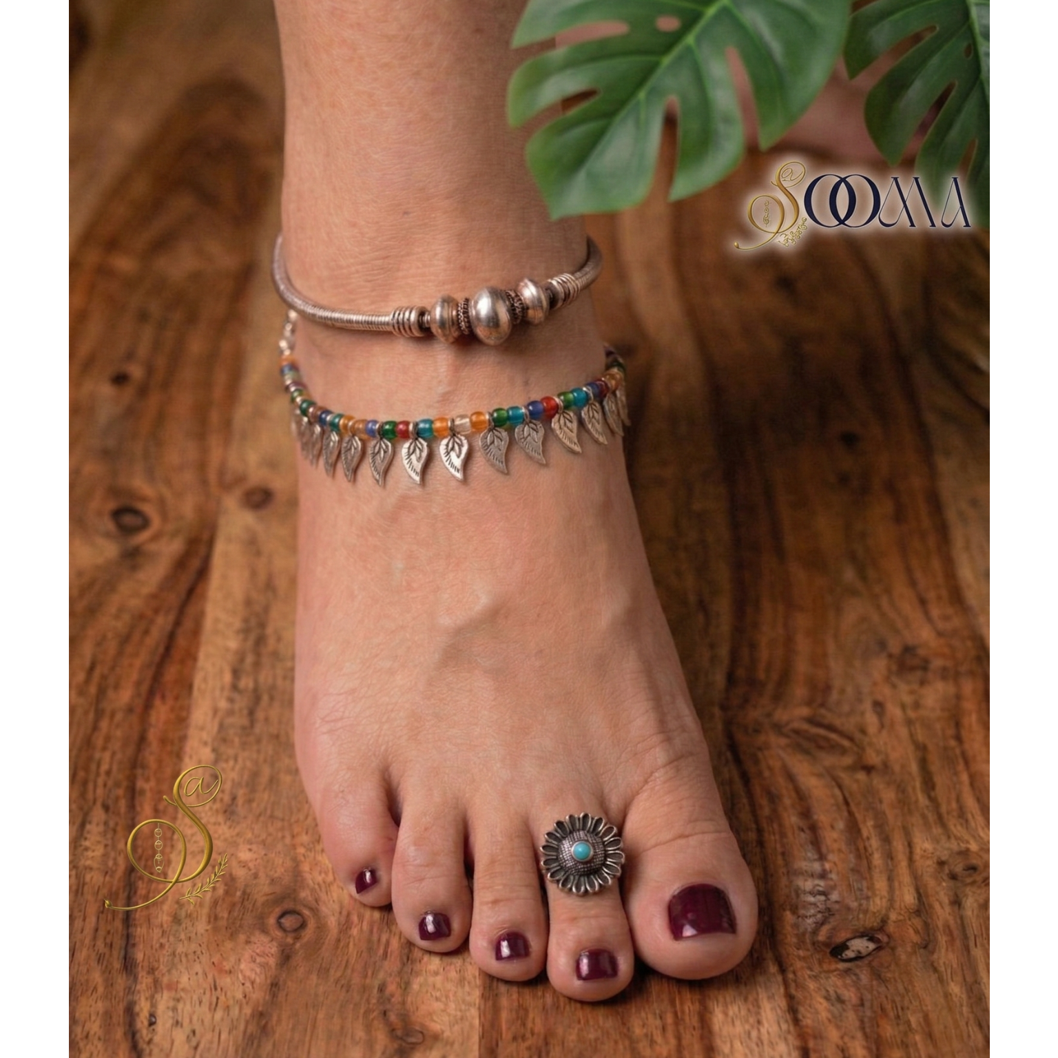 A Woman Wearing Boho Anklet Stack with Toe Ring featuring multi-colored beads and delicate charms.
