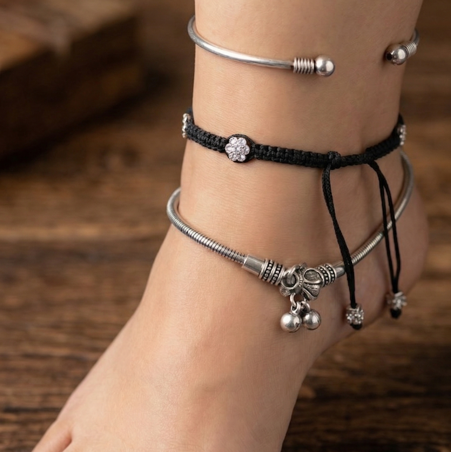 Closure side of elegant anklet stack featuring layered designs and a polished finish, perfect for office wear.