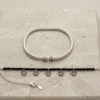 Elegant ankle bracelet with boho chic design on a stone background.