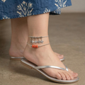 Elegant charm anklet stack featuring delicate chains and unique charms.