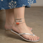 Elegant charm anklet stack featuring delicate chains and unique charms.