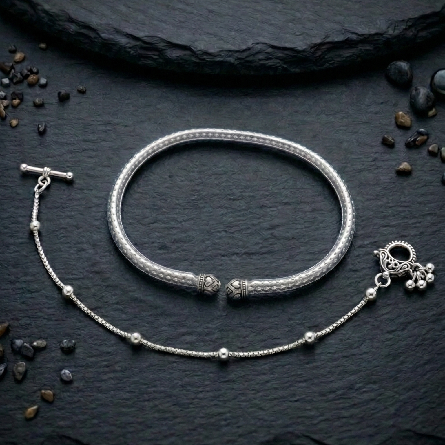 Oxidized silver payal anklet & kada with intricate design on a earthy surface