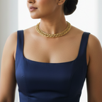 Woman wearing a navy blue dress and elegant braided brass hasli necklace, perfect statement officewear for modern Indian woman.
