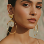 Close-up of a woman wearing Natural stone arrow earrings with unique gold design .