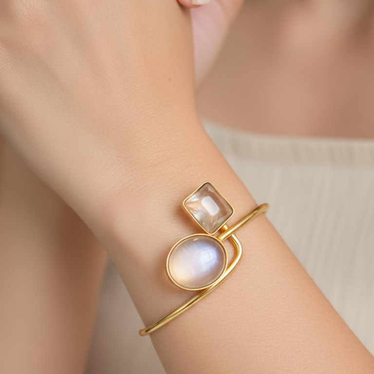 Clear stone gold plated minimalist bracelet for women, on a wrist against a neutral background