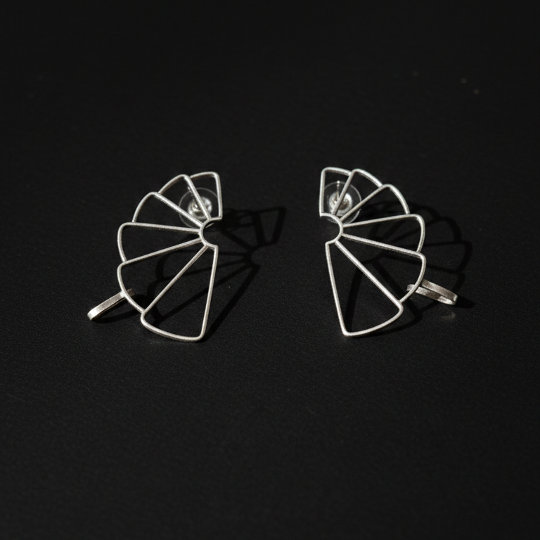 Pair of geometric earrings on a black background
