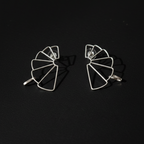 Pair of geometric earrings on a black background