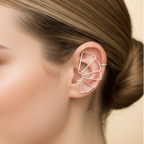 Close-up of a silver statement earcuff with intricate detailing.