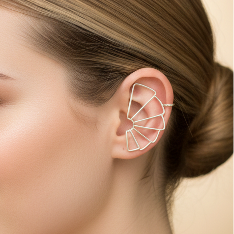 Close-up of a silver statement earcuff with intricate detailing.
