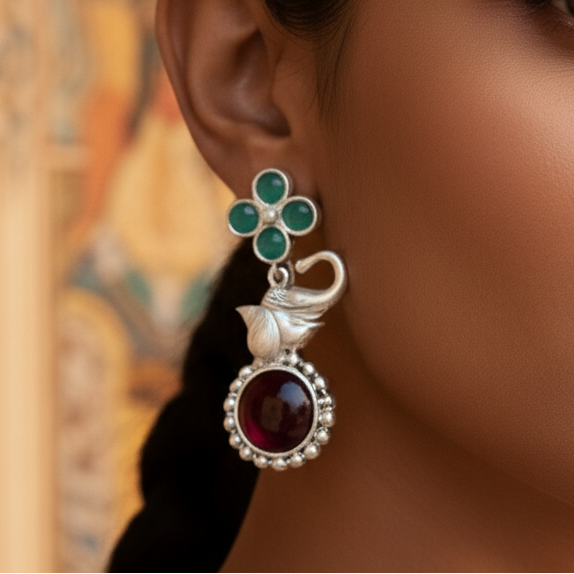 Close-up of a woman wearing Multicolor Elephant Stone Drop Earrings showcasing intricate stone work and elegant design.