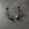 Close-up of oxidised stud earcuffs showing detailed texture and stud setting.