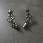 Close-up of oxidised stud earcuffs showing detailed texture and stud setting.