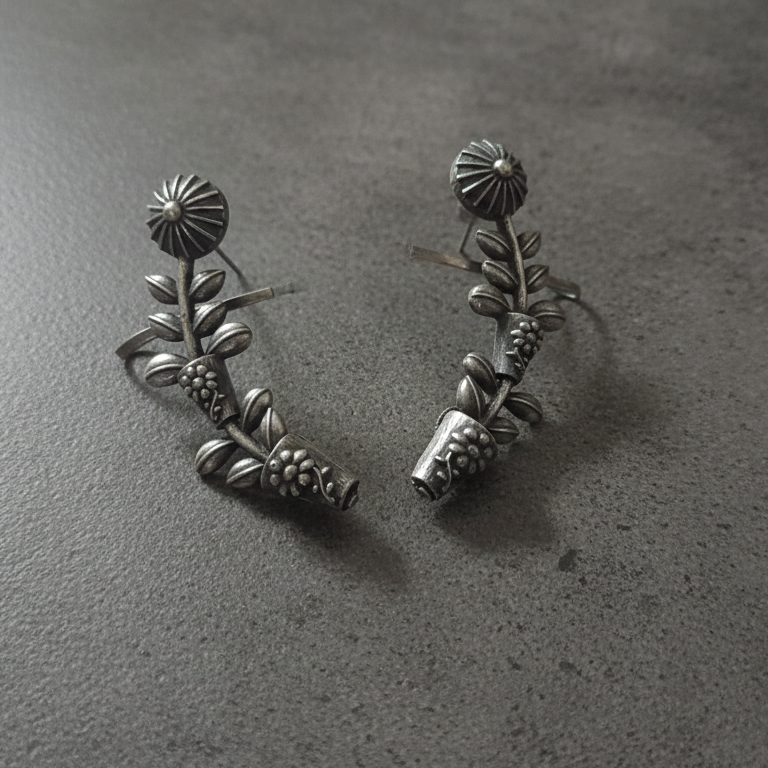 Close-up of oxidised stud earcuffs showing detailed texture and stud setting.