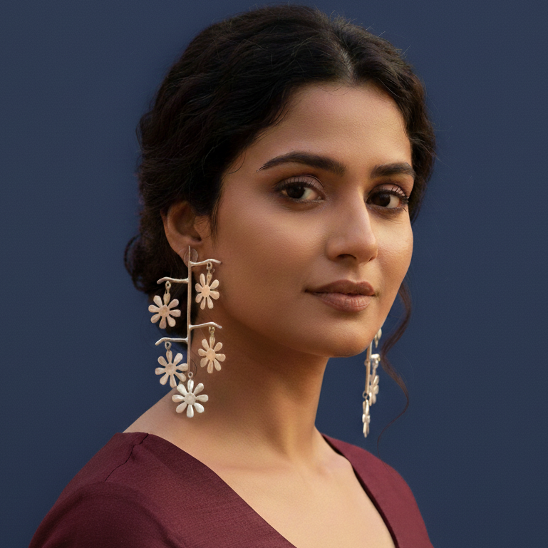 Woman wearing long floral oxidized silver contemporary earrings