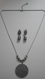 Boho silver neckpiece with intricate tribal design.