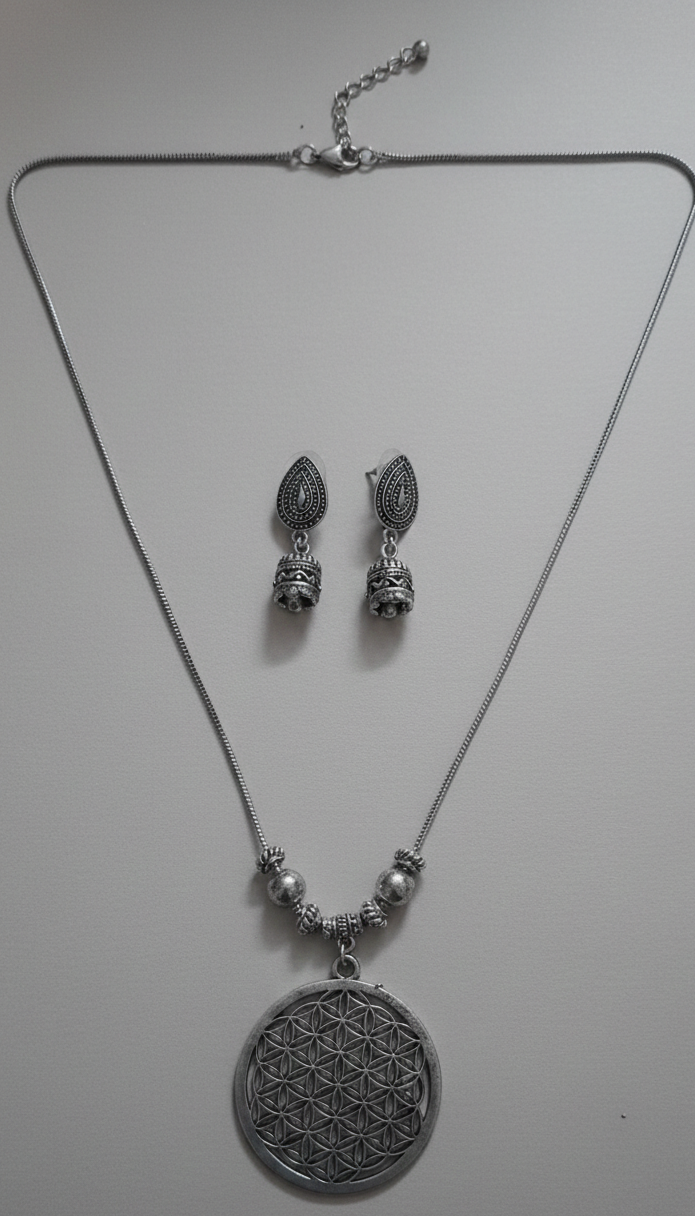Boho silver neckpiece with intricate tribal design.