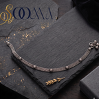 Sooma brand handcrafted oxidized silver double curb link anklet with rosette motifs displayed flat on a dark slate slate board with a black gift box