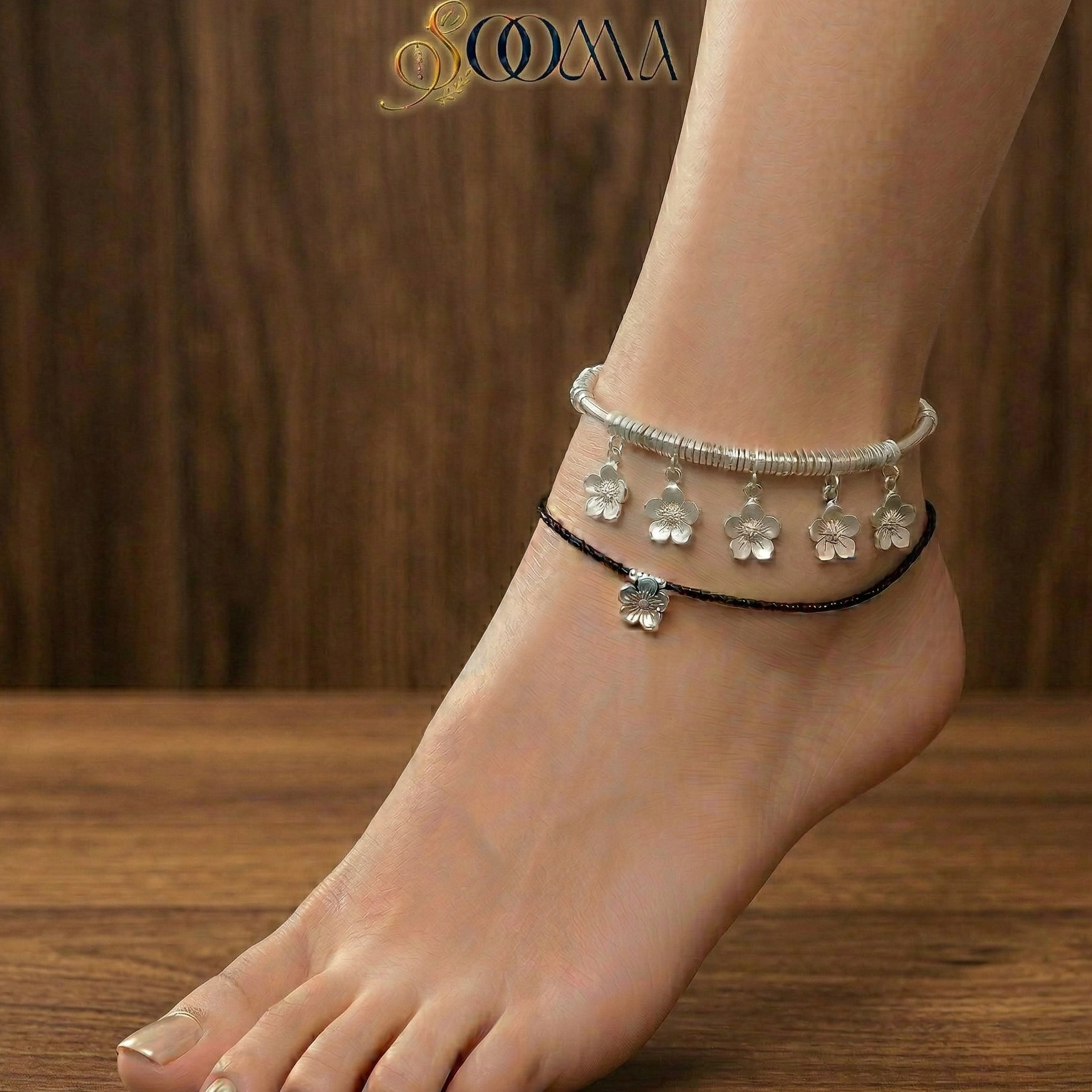 Close up of a woman wearing Charm Kada Stack showing the unique charms and polished metal finish.