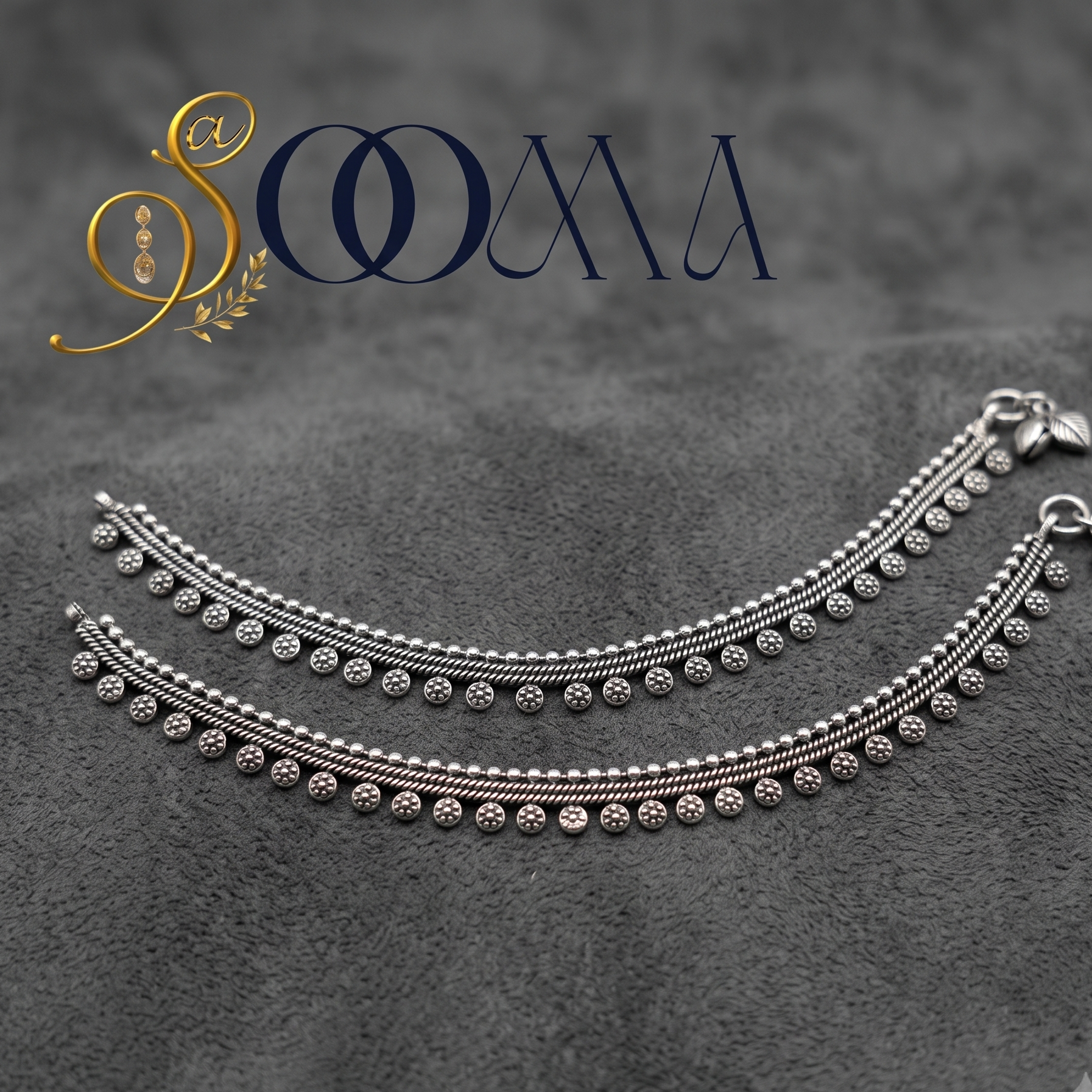 Sooma brand pair of oxidized silver floral drop payal anklets displayed flat on a textured grey surface