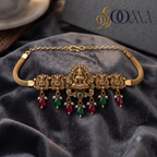 Sooma brand antique gold temple jewelry armlet featuring an engraved Goddess Lakshmi centerpiece flat lay on grey velvet fabric