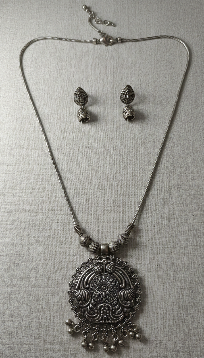 Handmade silver pendant for daily wear on grey background .