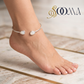 Model wearing sleek silver open cuff ankle kada featuring teardrop gemstone ends