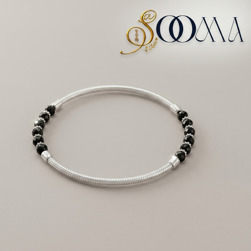 Silver anklet with black beads on a light gray background, featuring the brand 'Sooma'.