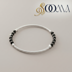 Silver anklet with black beads on a light gray background, featuring the brand 'Sooma'.