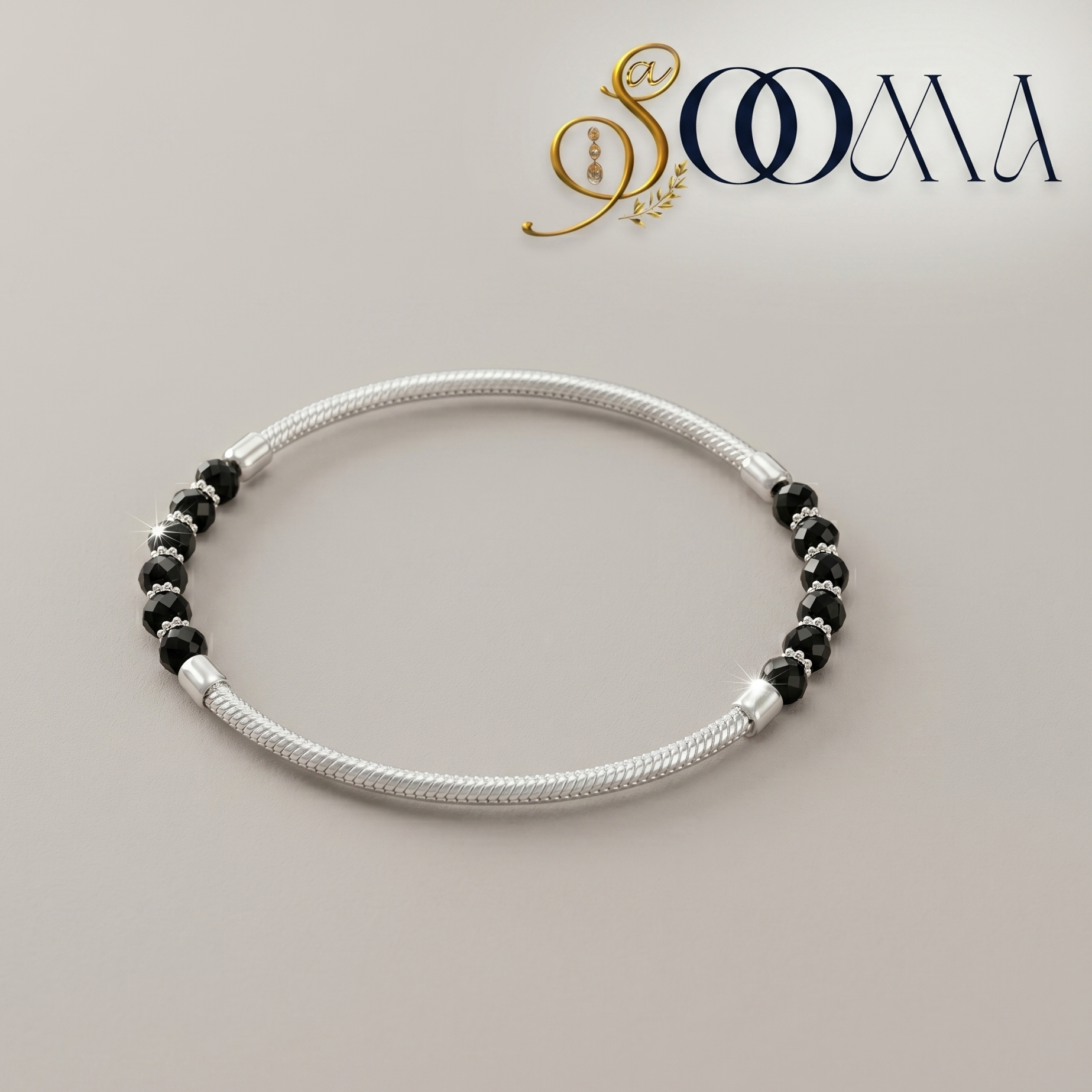 Silver anklet with black beads on a light gray background, featuring the brand 'Sooma'.