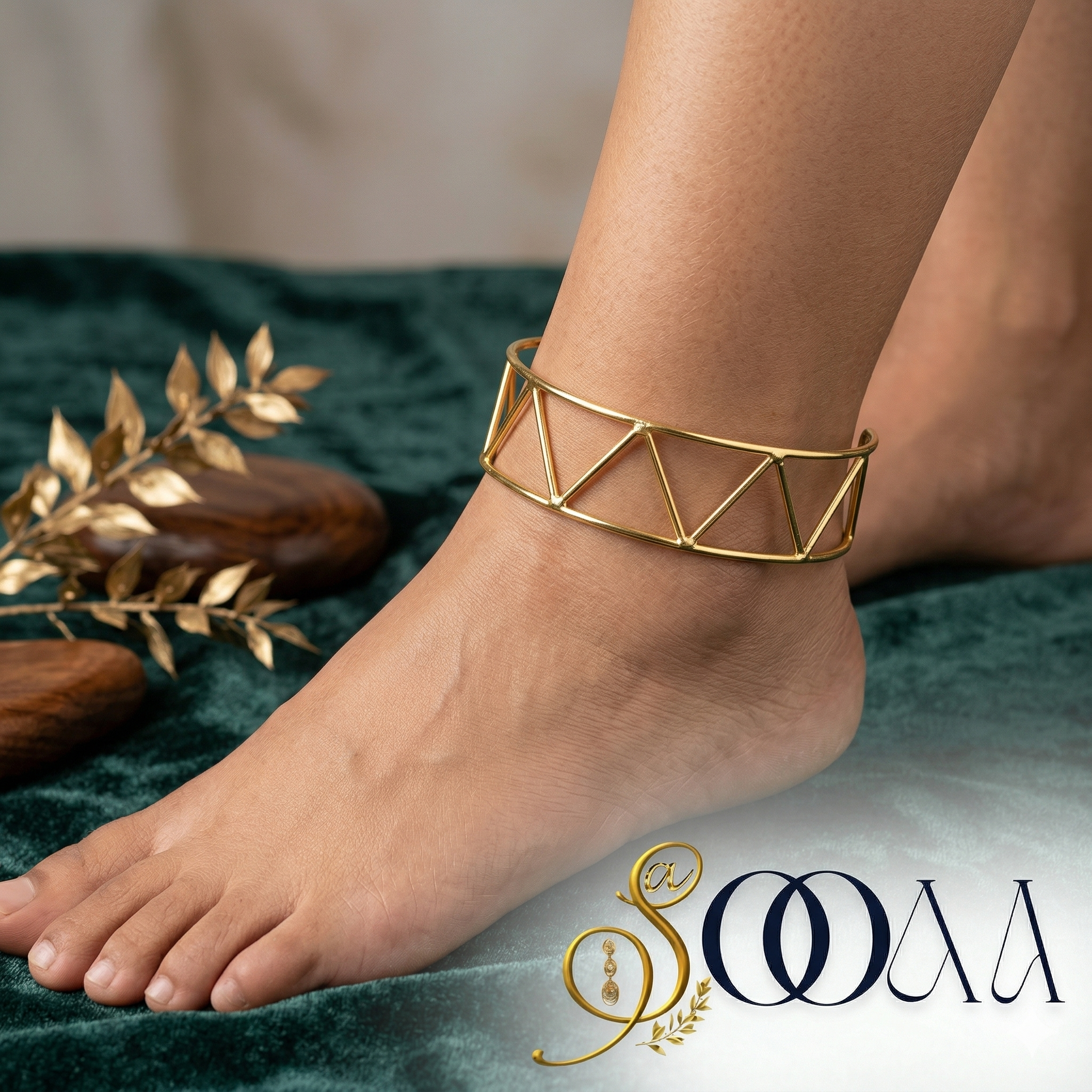Gold geometric anklet on a foot with a brand logo in the corner