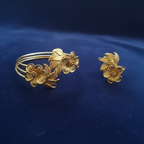 Gold floral Bracelet & Ring set on a blue fabric background