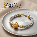 Gold and silver ankle bracelet on a metallic plate with 'Sooma' branding.
