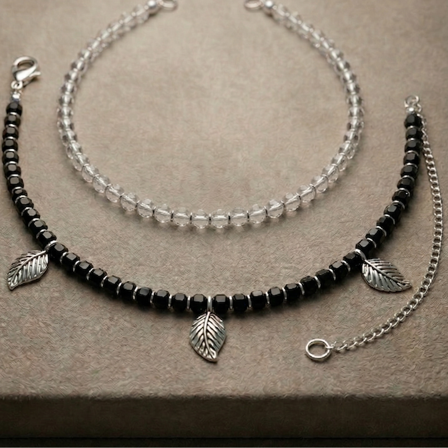 Close-up of beaded and charm anklet stack on ankle