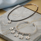 Close-up of the Charm Kada Stack showing the unique charms and polished metal finish.