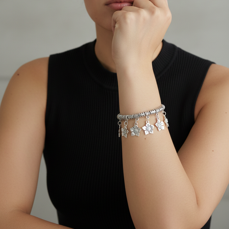 Woman wearing a silver charm bangle