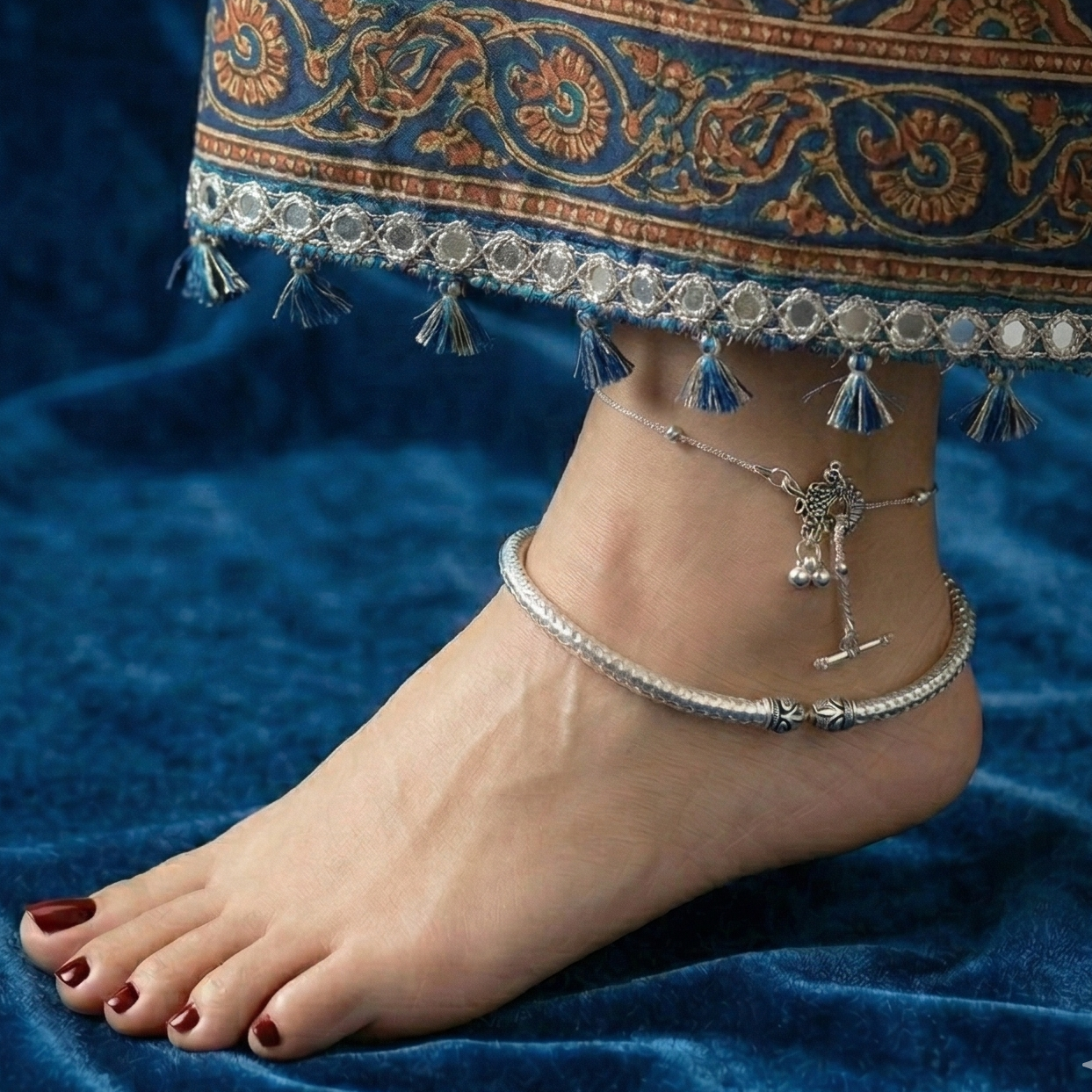 Close-up of a foot wearing Oxidized silver payal anklet with intricate design