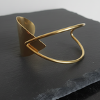 Gold bracele ton a dark stone surface